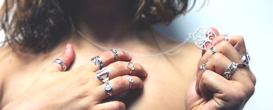 Silver rings, a silver necklace and other silver jewellery on a woman