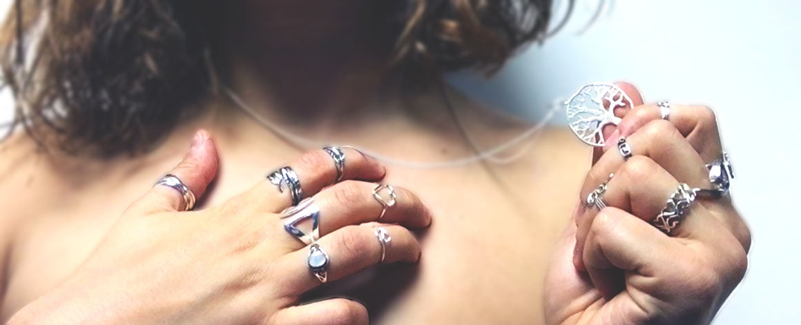 Silver rings, a silver necklace and other silver jewellery on a woman