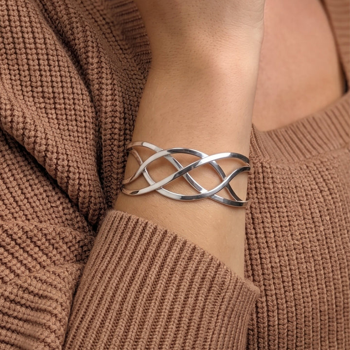 Sterling silver Celtic cuff bangle — polished braided crossover design