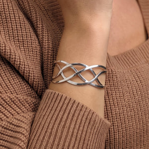 
                  
                    Sterling silver Celtic cuff bangle — polished braided crossover design
                  
                