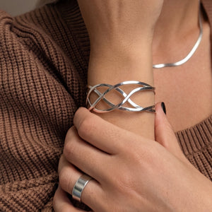 
                  
                    Wide Celtic knot bangle in 925 sterling silver — woven knotwork cuff
                  
                