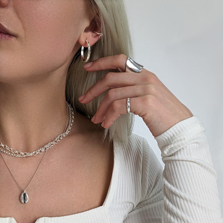 Sterling silver diamond cut hoops with concave ring, chunky rolo chokers and cowrie shell necklace