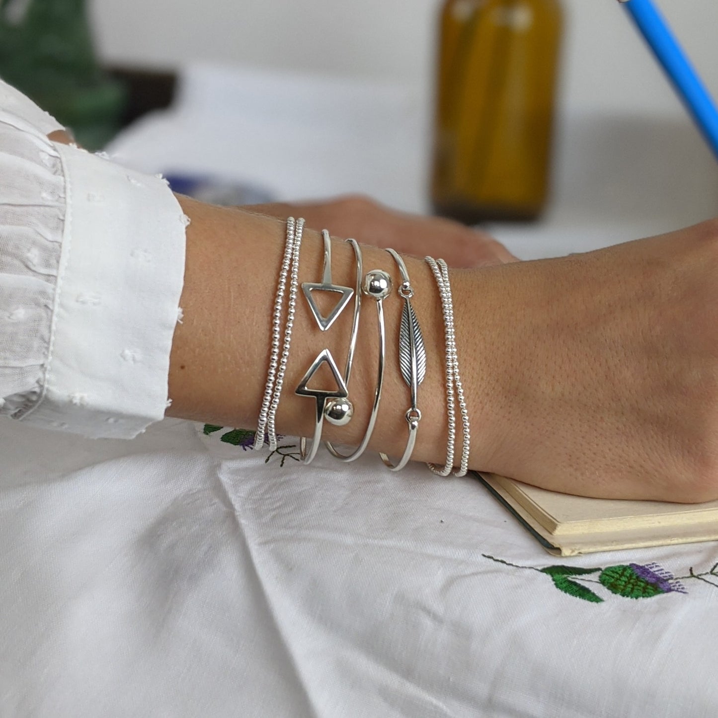 Sterling silver bead bracelet with torque, wrap and feather bangle stack