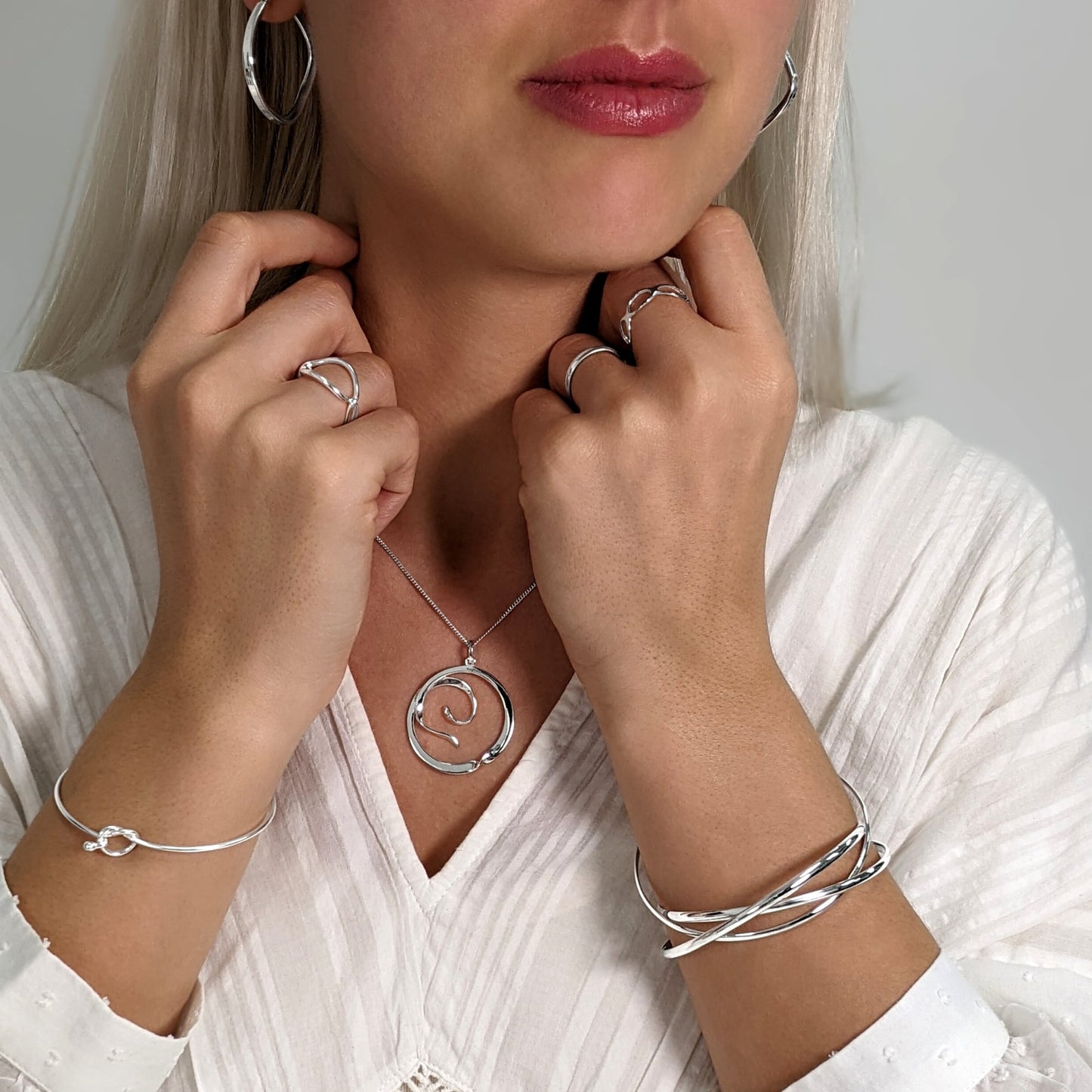 Sterling silver triple Russian bangle styled with chunky hoops, stacking rings and pendant necklace