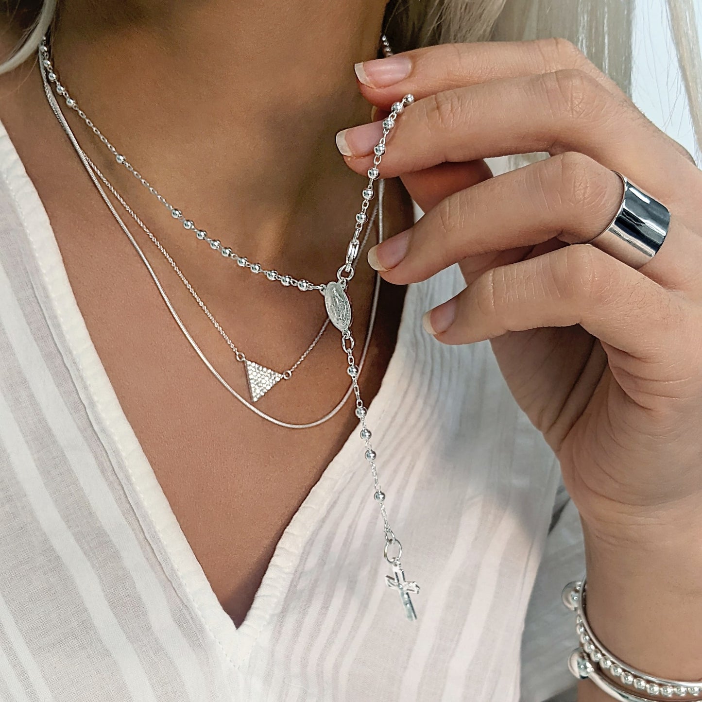 Sterling silver rosary necklace styled with CZ triangle pendant and chunky cigar ring