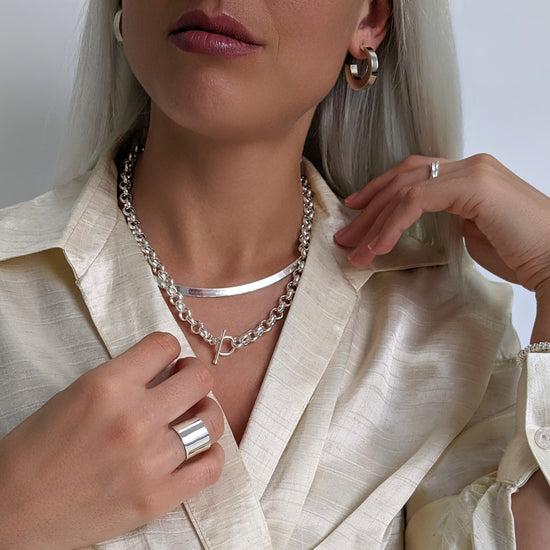 
                    
                      Sterling silver extra chunky hoops styled with chunky rolo chain and wide band ring
                    
                  