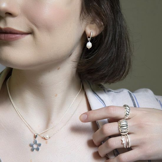 
                    
                      925 sterling silver CZ band ring styled with ripple-textured rings and pearl pendant necklace
                    
                  