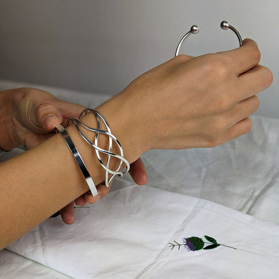 
                    
                      Wide entwined Celtic bangle in sterling silver — statement cuff
                    
                  