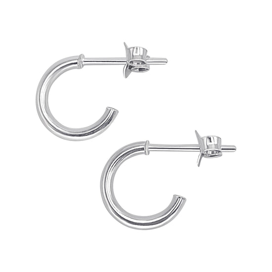 A pair of sterling silver huggie hoop earrings with a butterfly back closure, displayed against a white background.