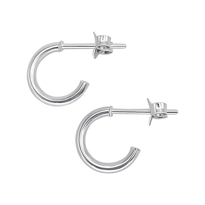 A pair of sterling silver huggie hoop earrings with a butterfly back closure, displayed against a white background.