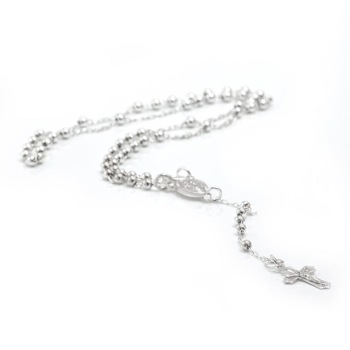 Close-up of sterling silver rosary necklace — Miraculous Medal Virgin Mary medallion and crucifix