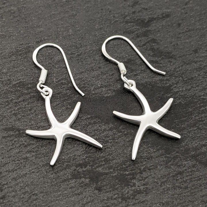 Close-up of sterling silver starfish charm earrings