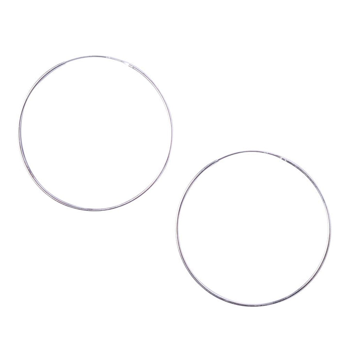 Two large sterling silver sleeper hoop earrings against a white background