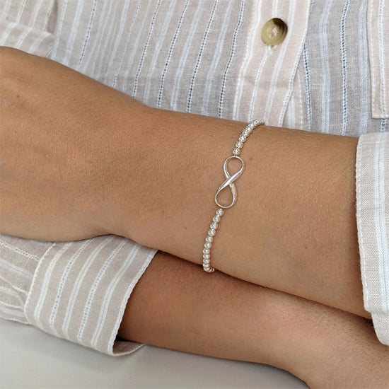 
                    
                      Sterling silver ball bead bracelet with figure-of-eight infinity symbol charm
                    
                  