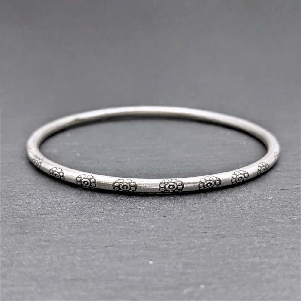 
                  
                    Pure Silver Hill Tribe Engraved Flower Round Tube Stacking Bangle
                  
                