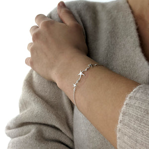 
                  
                    Sterling Silver Triple Starfish Star Charm Cable Chain Bracelet
                  
                