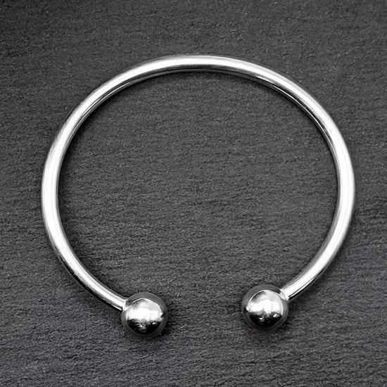 
                    
                      Close-up of sterling silver torque bangle
                    
                  