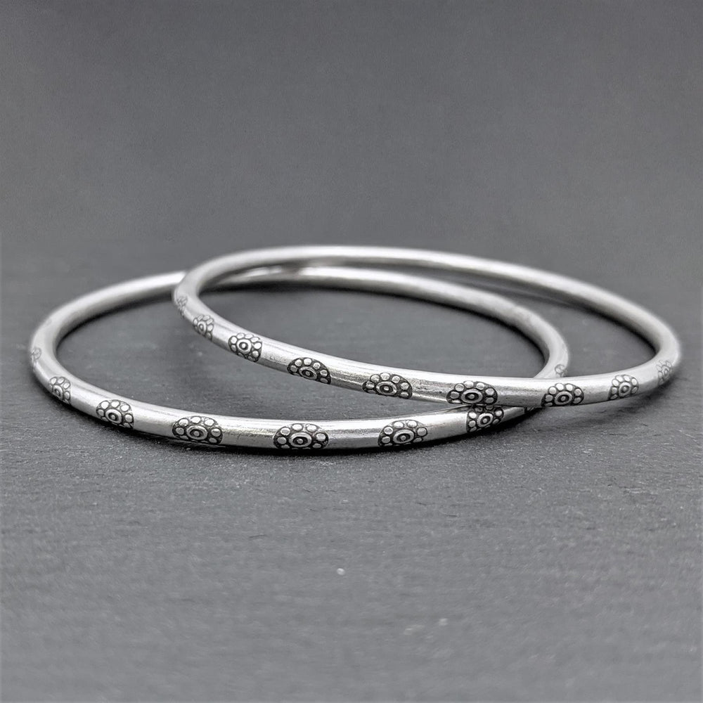 
                  
                    Pure Silver Hill Tribe Engraved Flower Round Tube Stacking Bangle
                  
                
