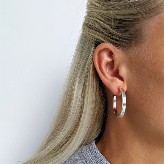 
                    
                      Sterling silver square tube hoop earrings — flat-edge hoops with polished finish
                    
                  