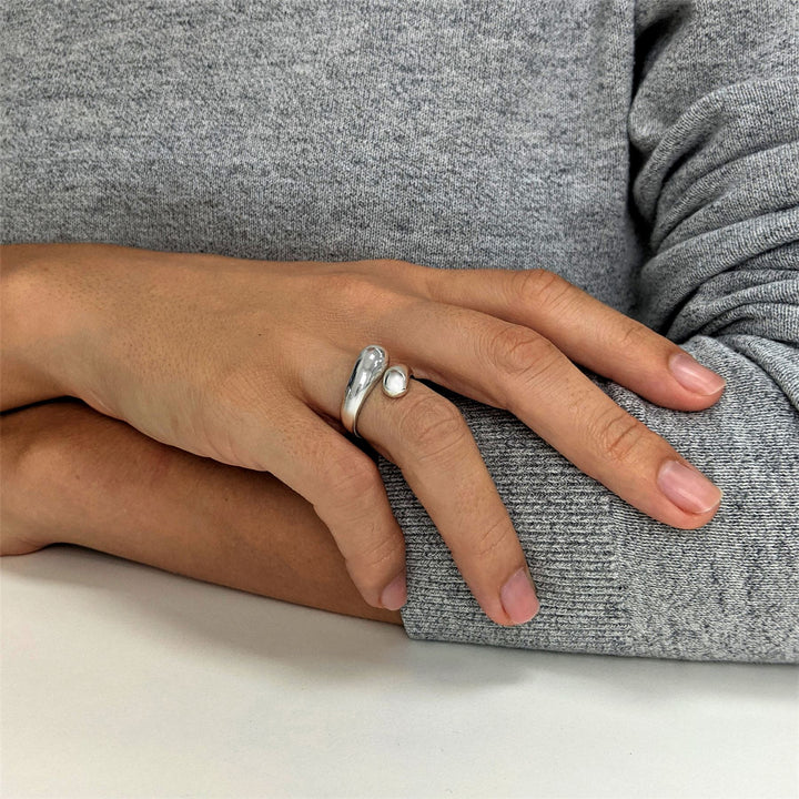 Sterling silver chunky teardrop ring with open wraparound design.