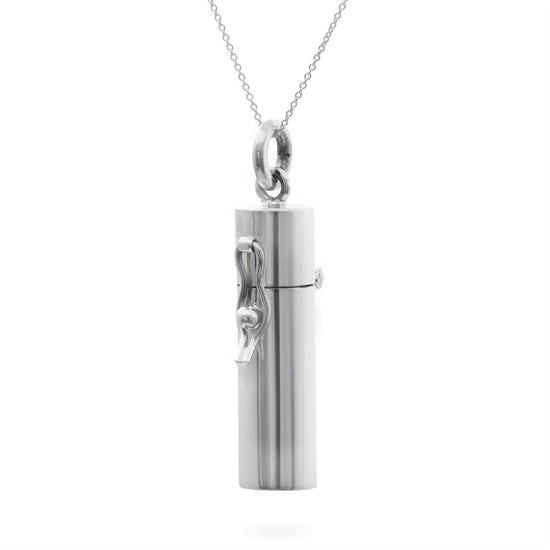 A sterling silver pendant necklace with a capsule-shaped pill box attached to a curb chain.