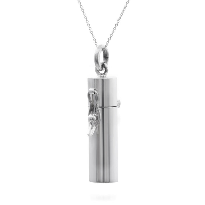 A sterling silver pendant necklace with a capsule-shaped pill box attached to a curb chain.