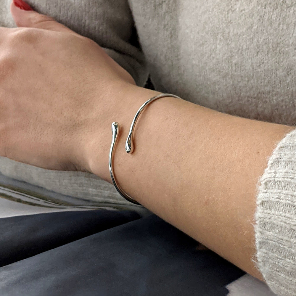 
                  
                    Sterling Silver Thin Wire Round Tube Teardrop Wrap Adjustable Bangle
                  
                