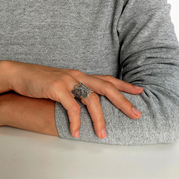 Side profile of sterling silver filigree butterfly thumb ring with detailed wing design