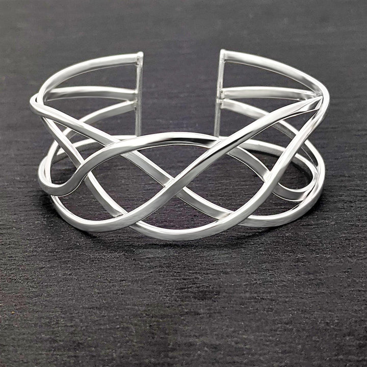 Close-up of sterling silver Celtic knot bangle with intricate braided knotwork